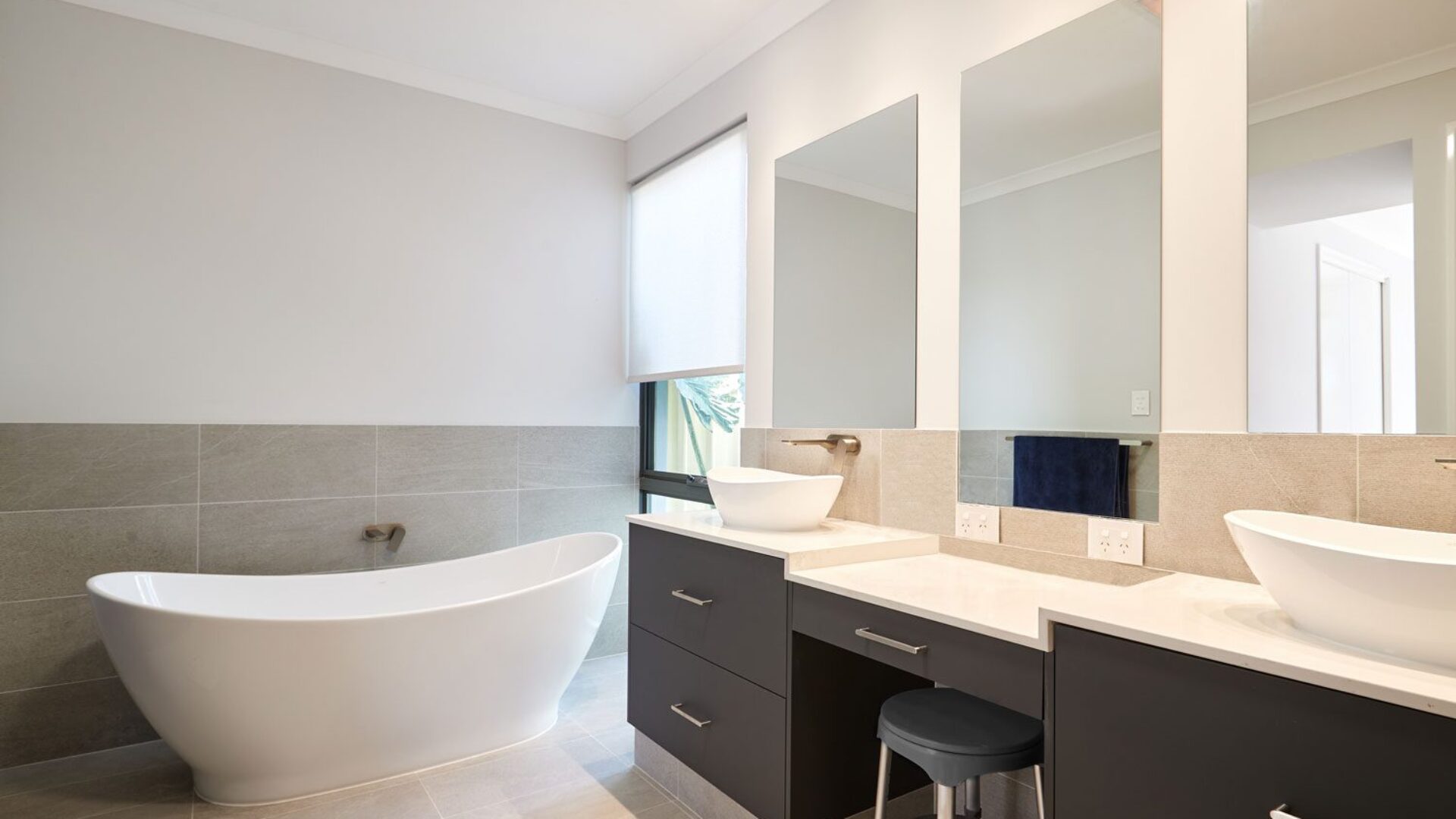 Bathroom with freestanding bath and twin basin vanity