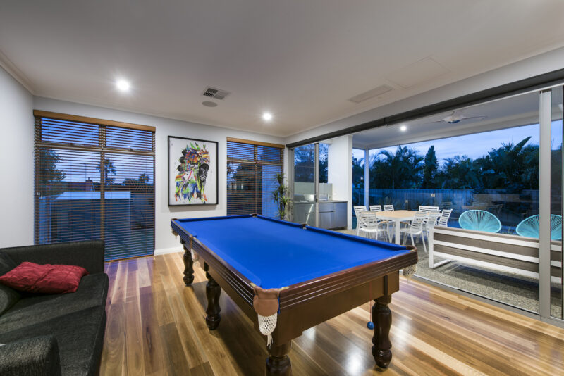 Residential Attitudes - Pool table with wooden floor and swimming pool in background