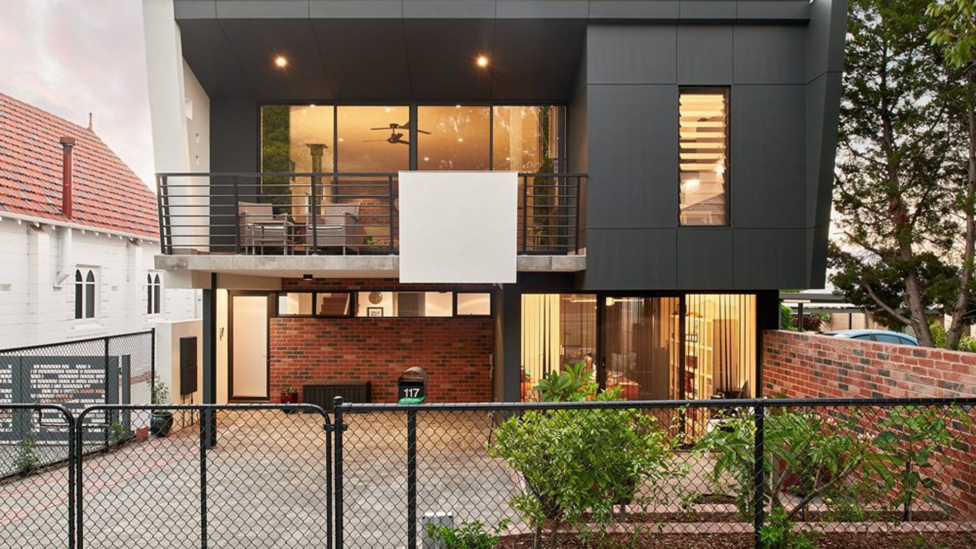 Urbanite narrow lot home exterior beside a character home
