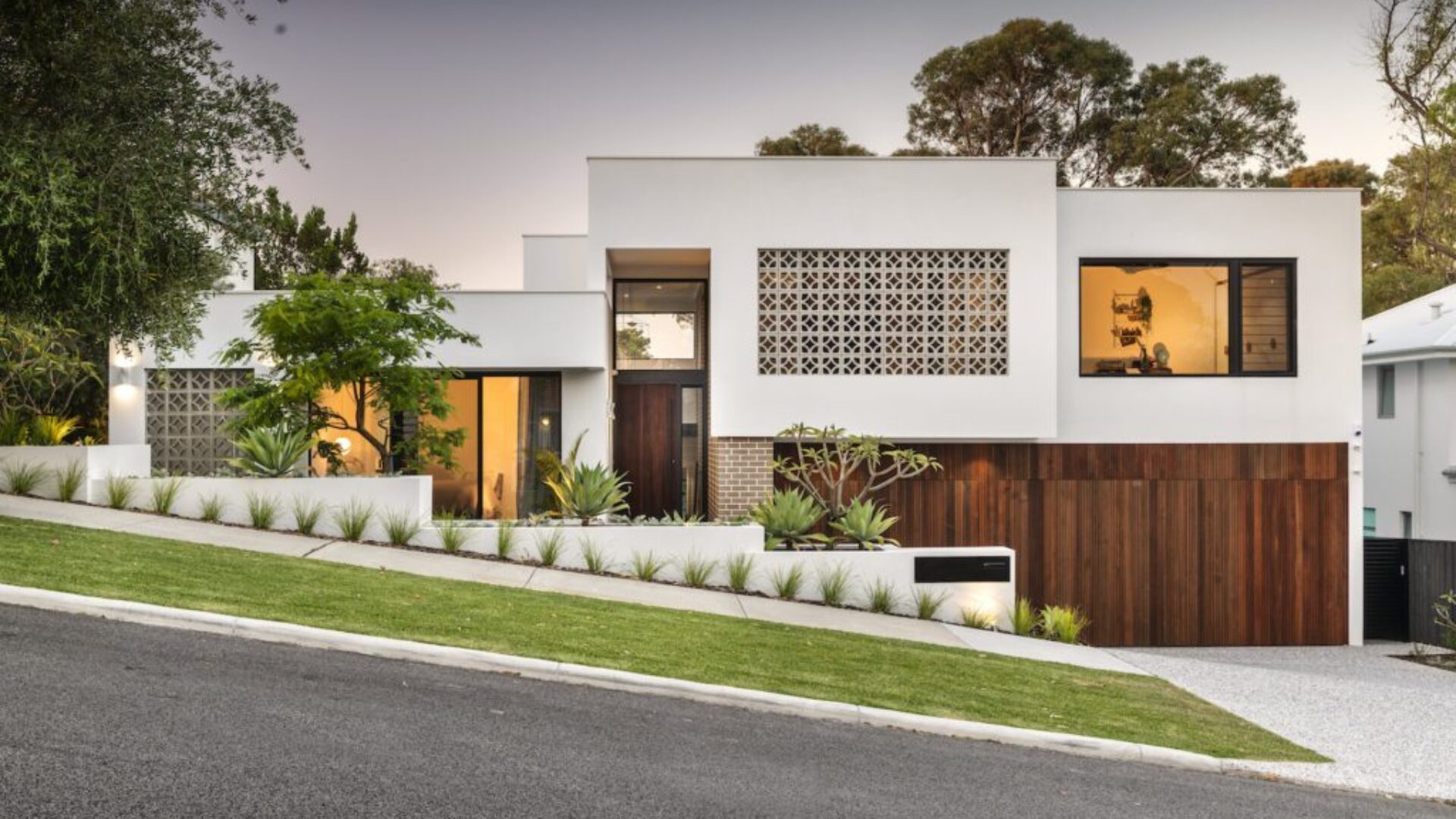Modern home facade with breeze block screening and timber entry