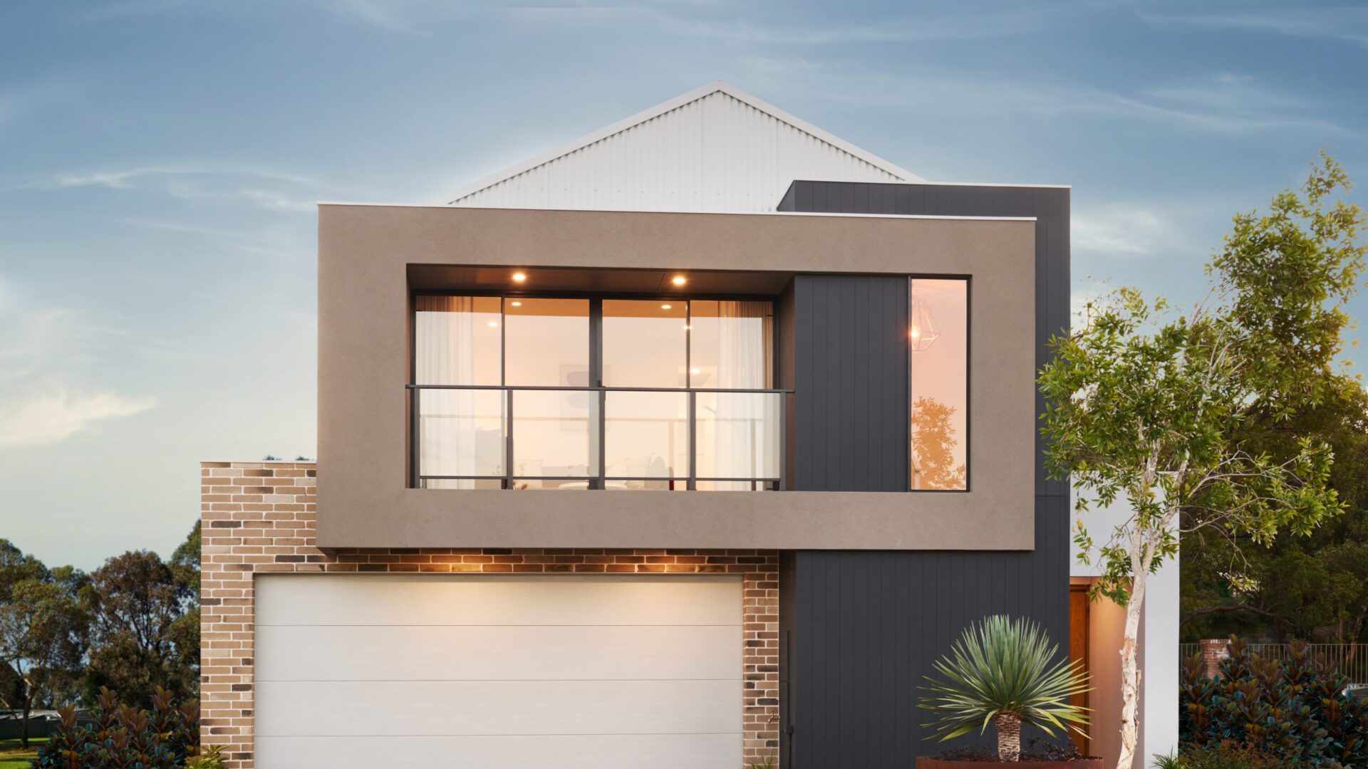 The Art House display home facade at dusk with gable roofline and double garage
