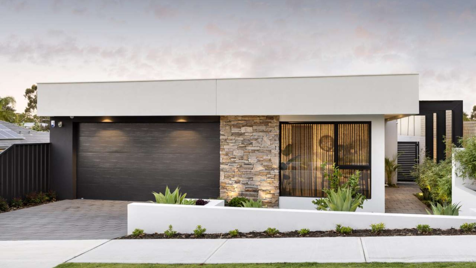 Single storey home facade with stone feature wall and double garage