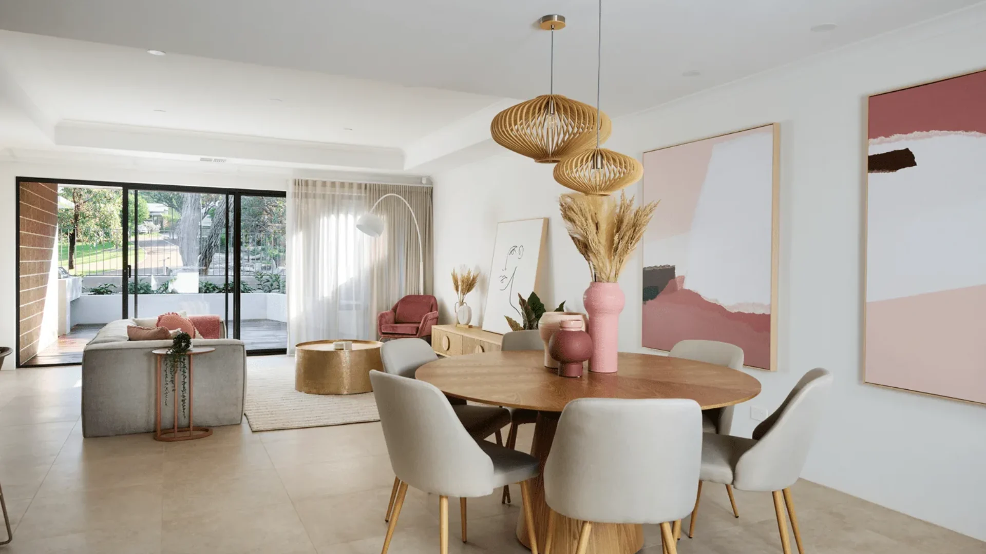 The Art House display home dining area with rattan pendants and feature artwork