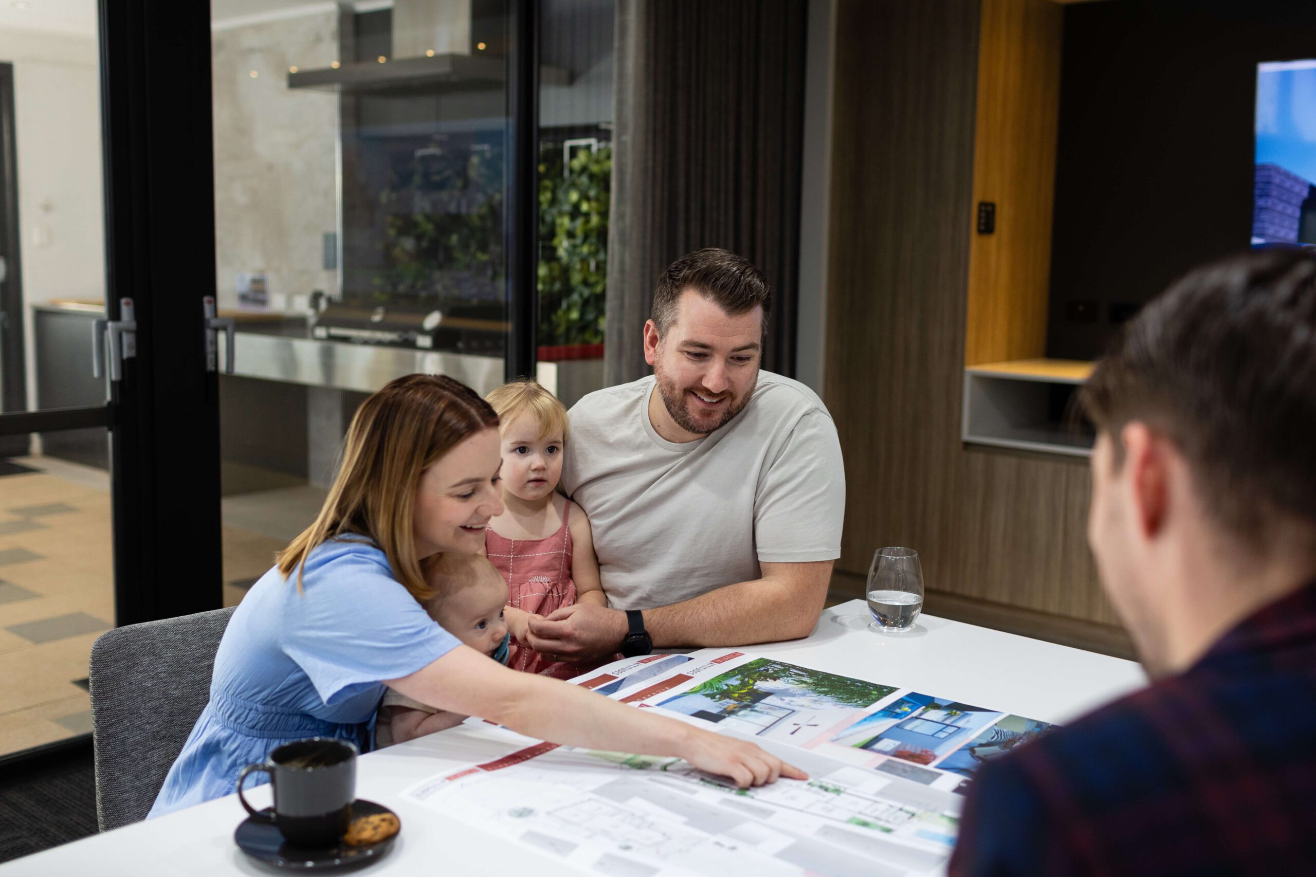 Family reviewing home plans with a Residential Attitudes consultant