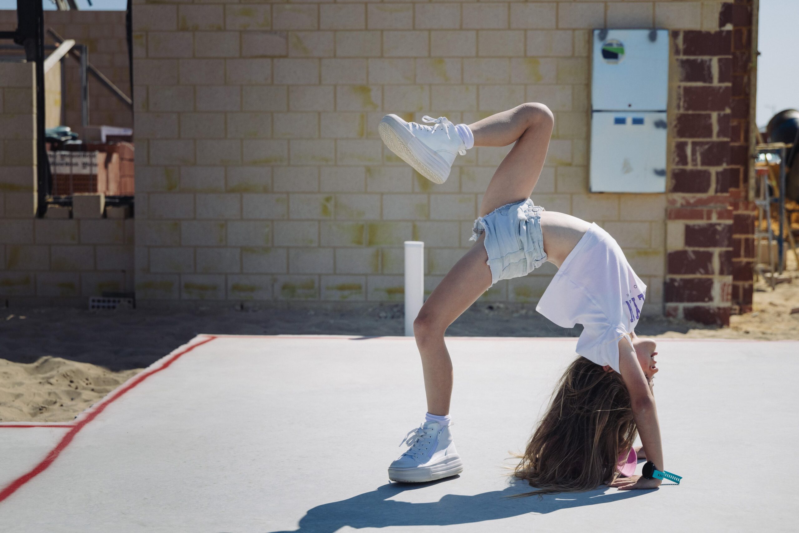Child doing a handstand on a new home slab