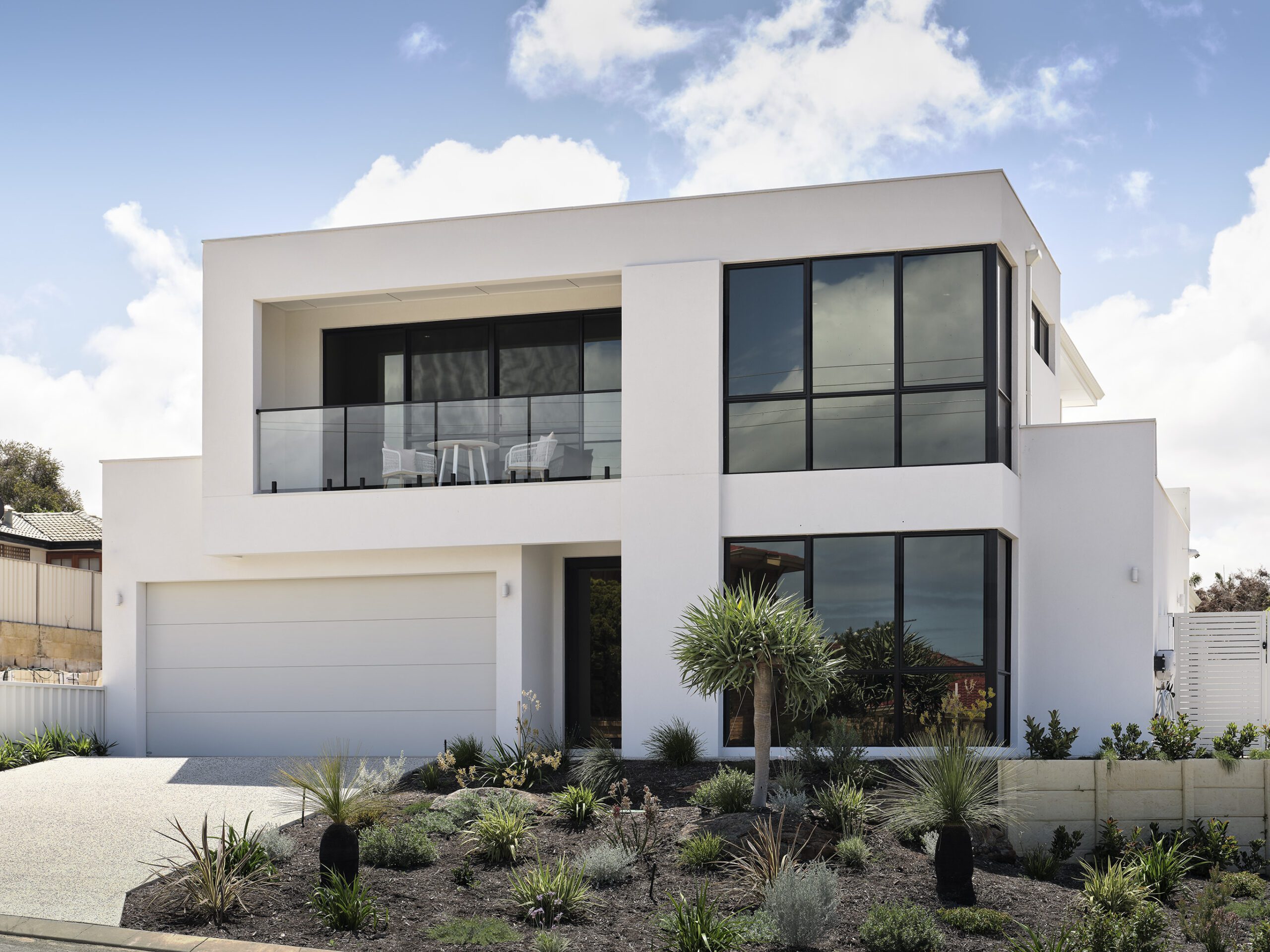 Front facade of a double storey client home with expansive windows