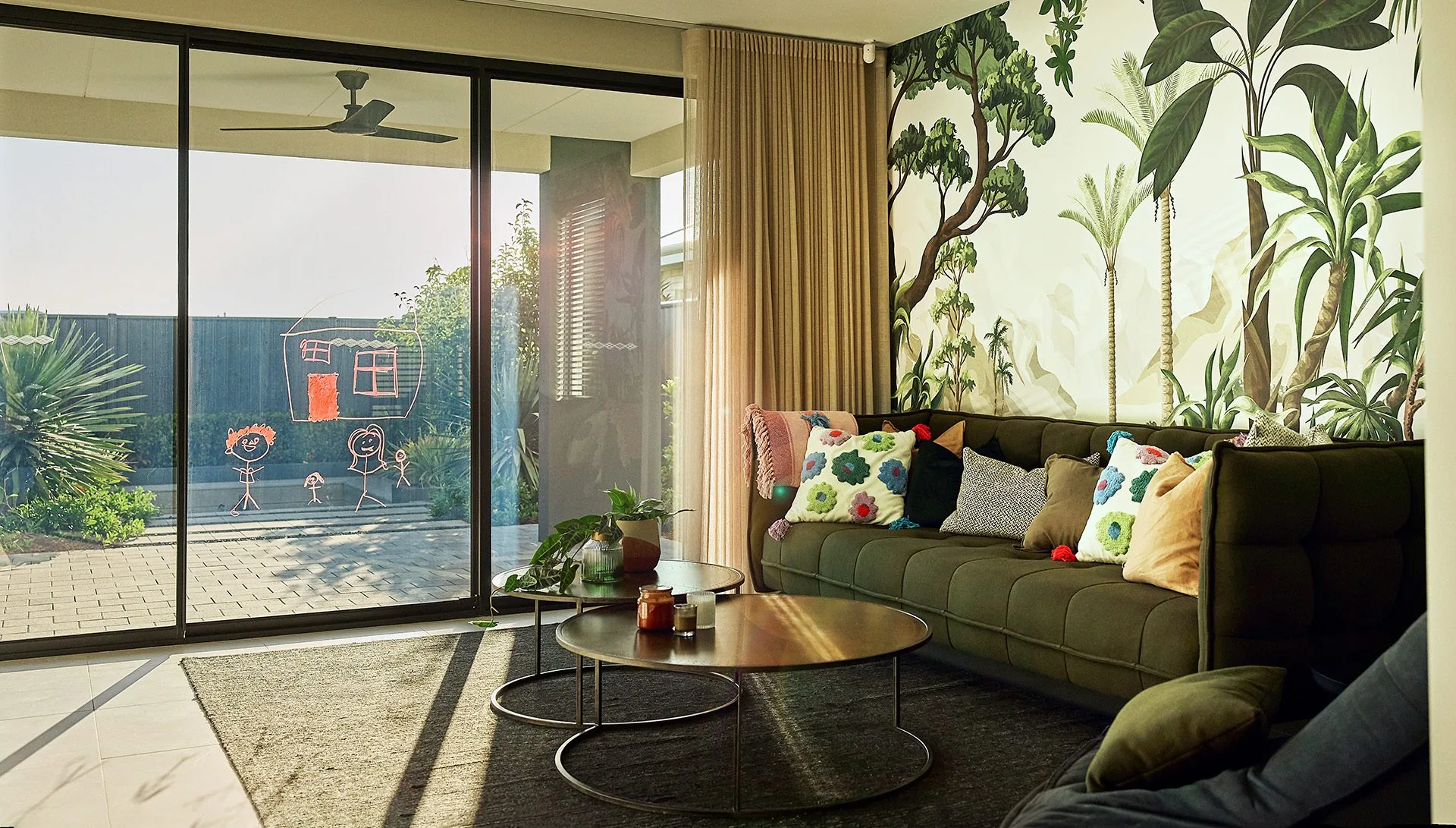 There is a drawing scrawled onto freshly polished glass doors leading to a beautiful outdoor entertainment area, and firepit. At Residential Attitudes, this is what a perfect home for imperfect lvies looks like.